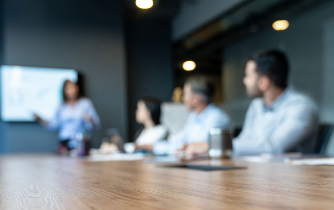 people at a meeting (blurry image)